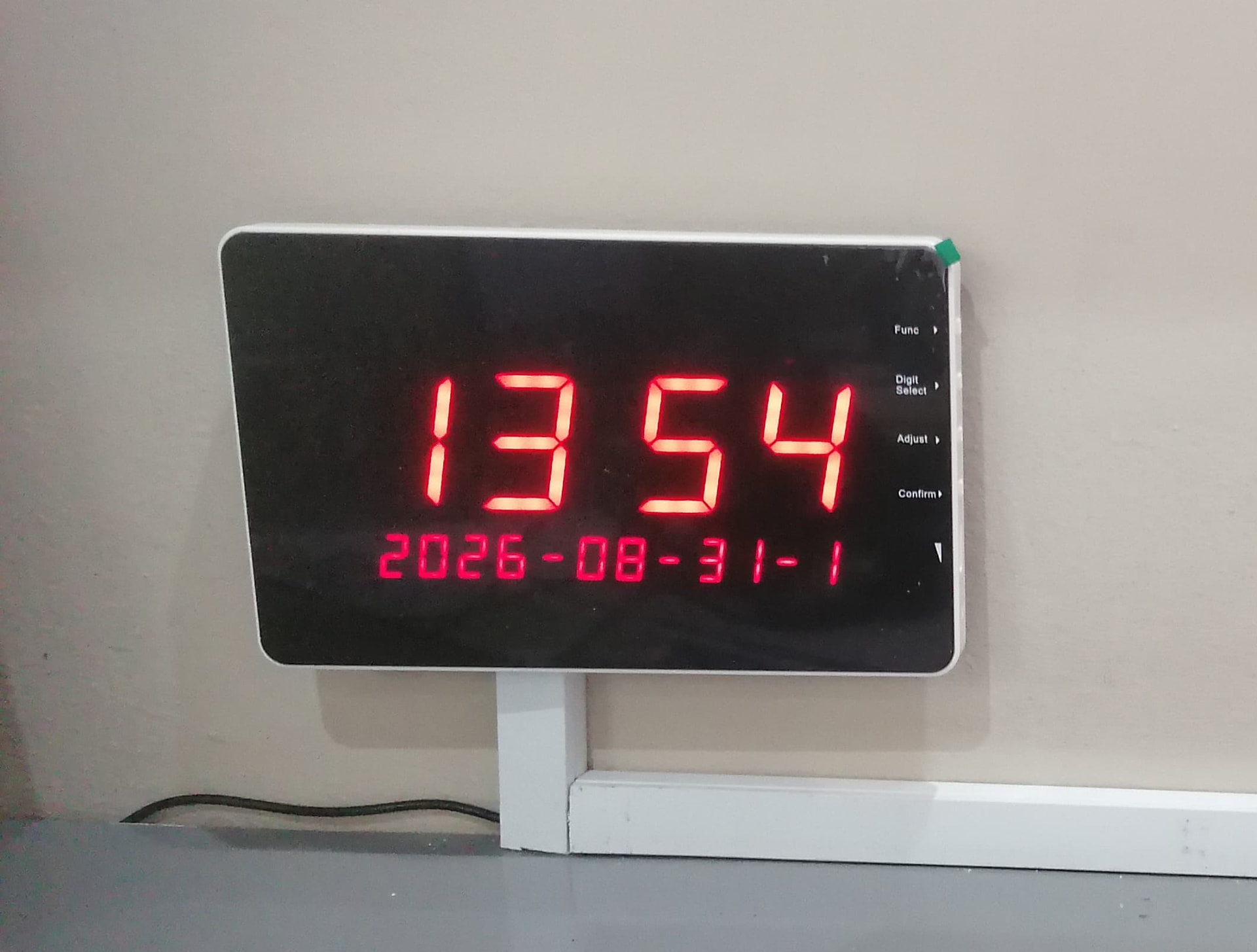 A B-99G Display Panel installed at a client site, showing the time and date on standby