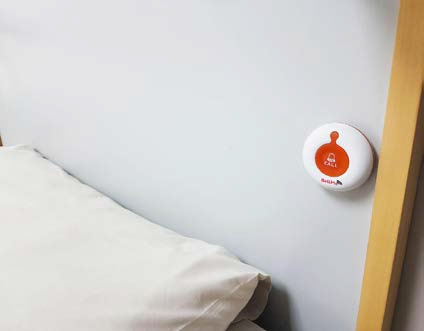 BellMe B-A1-WL Call Button mounted on the wall next to a hospital bed