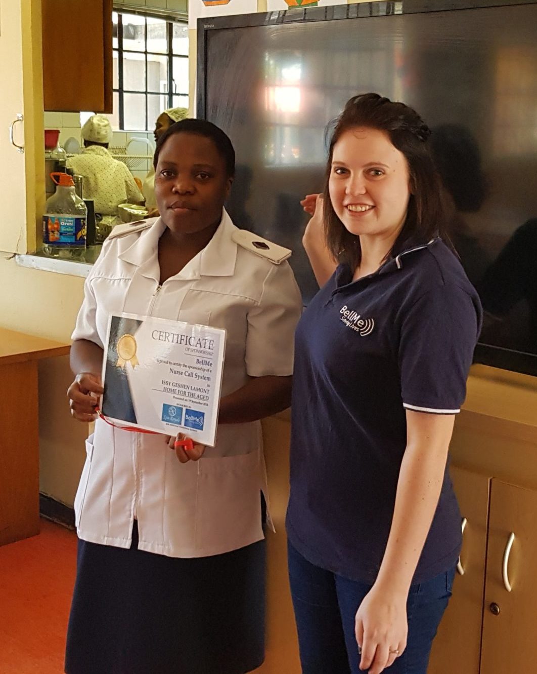 BellMe presenting a certificate of sponsorship for a nurse call system to a care worker at Issy Geshen Lamont Home for the Aged